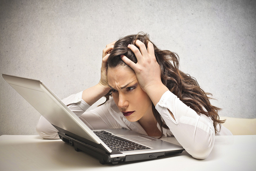 Stressed businesswoman looking over business disaster plan